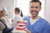 A man holding dentures 